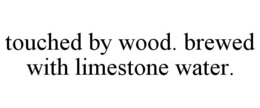 TOUCHED BY WOOD. BREWED WITH LIMESTONE WATER. trademark