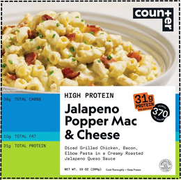 COUNTER HIGH PROTEIN JALAPENO POPPER MAC & CHEESE DICED GRILLED CHICKEN, BACON, ELBOW PASTA IN A CREAMY ROASTED JALAPENO QUESO SAUCE NET WT. 10 OZ (284G) COOK THOROUGHLY • KEEP FROZEN U.S. INSPECTED AND PASSED BY DEPARTMENT OF AGRICULTURE EST. 17644 31G PROTEIN PER SERVING 370 CALORIES PER SERVING SERVING SUGGESTION 38G TOTAL CARBS 10G TOTAL FAT 31G TOTAL PROTEIN trademark